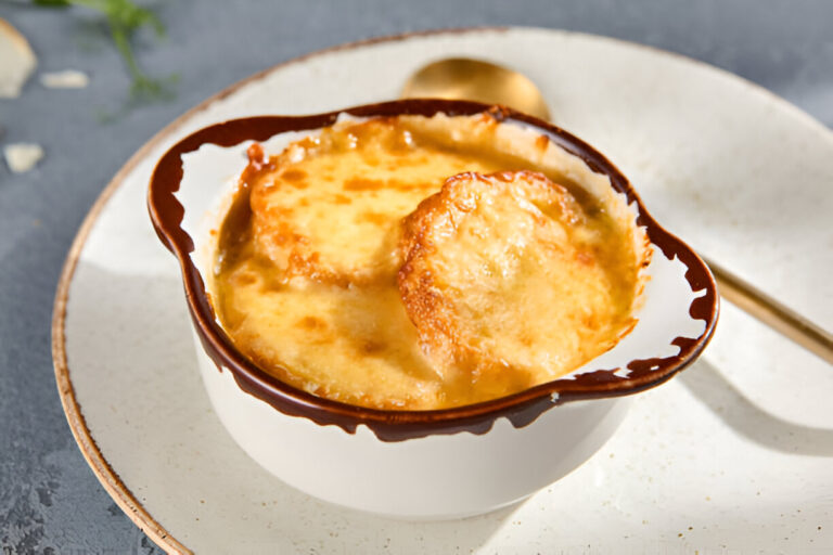 A bowl of French onion soup topped with melted cheese and toasted bread.