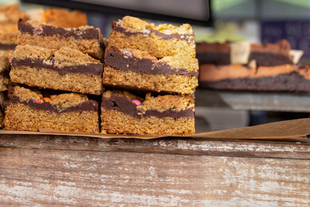 Stacked squares of chocolate dessert bars with a crumbly top and layered chocolate filling.