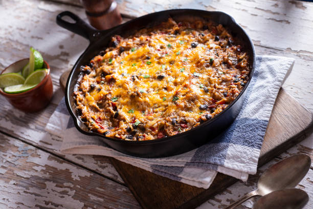 A delicious cheesy baked dish in a cast iron skillet, served on a rustic wooden table.