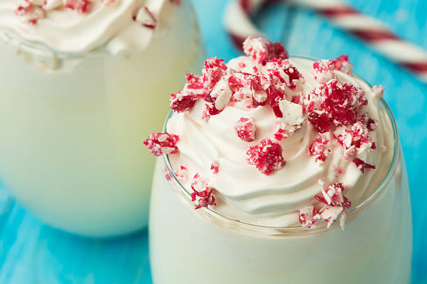 Close-up of a festive drink topped with whipped cream and crushed peppermint candies.