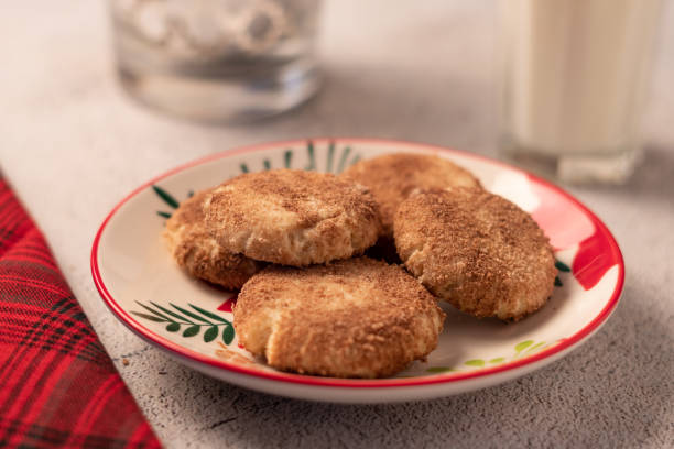 Plate of cinnamon sugar cookies next to a glass of milk