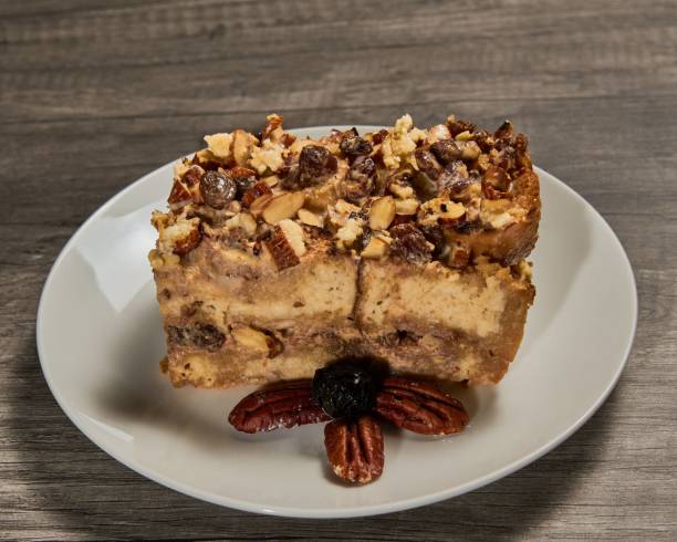 A slice of dessert featuring nuts and raisins on a white plate