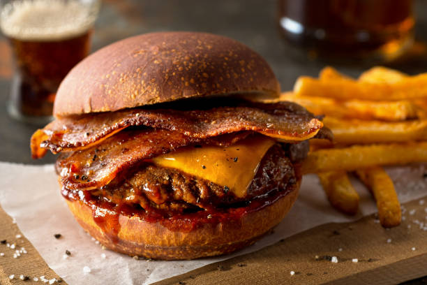 A delicious cheeseburger with bacon and fries on the side.