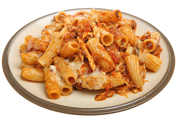 Plate of baked rigatoni pasta topped with cheese and marinara sauce