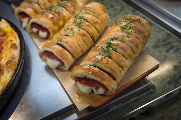 Freshly baked stuffed bread rolls with cheese and meat, garnished with parsley