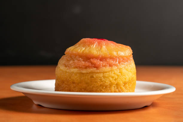 A delicious slice of pineapple upside-down cake on a white plate