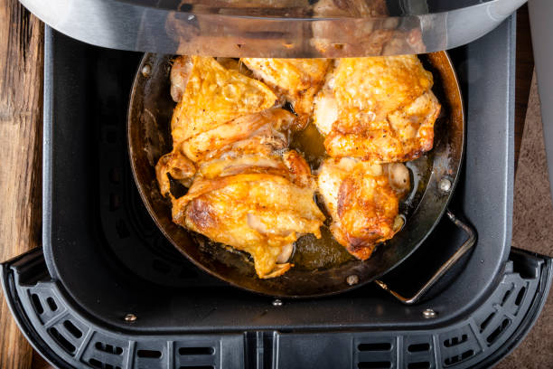 Cooked chicken thighs in an air fryer.