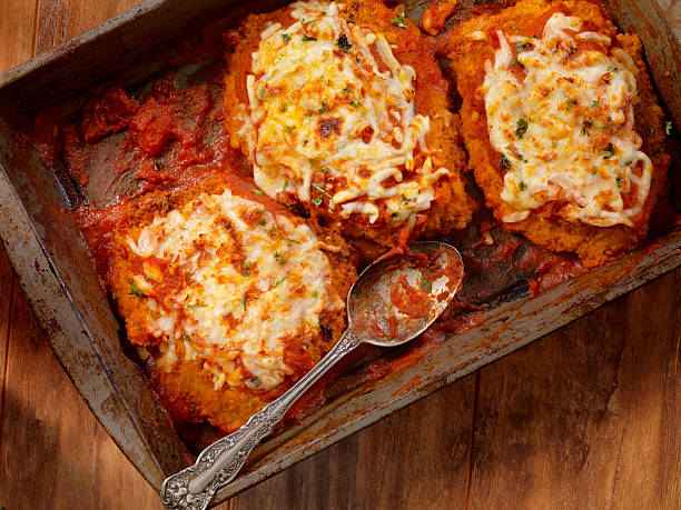 Baked crispy chicken with melted cheese in a rustic serving dish