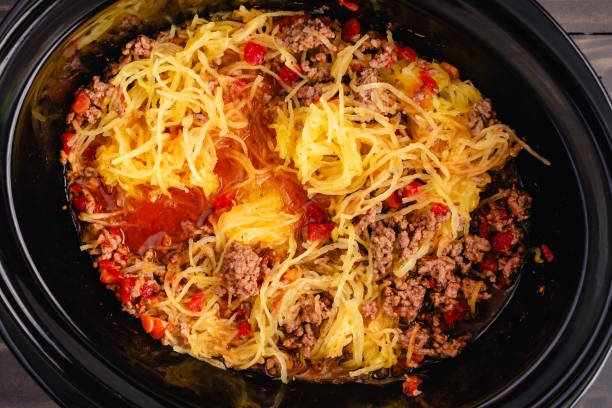 A slow cooker filled with spaghetti squash and ground beef mixture.