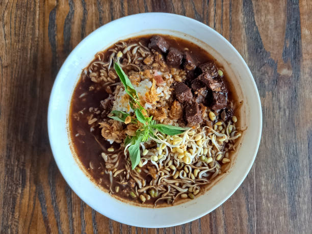 A bowl of rich, flavorful noodle soup with tender beef, bean sprouts, and herbs.