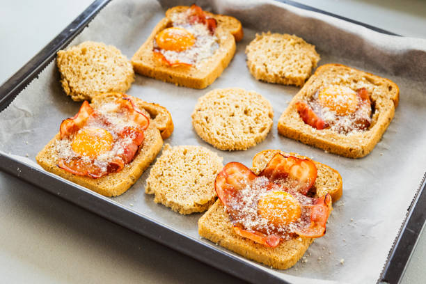 Baked egg and bacon on toast in a baking tray