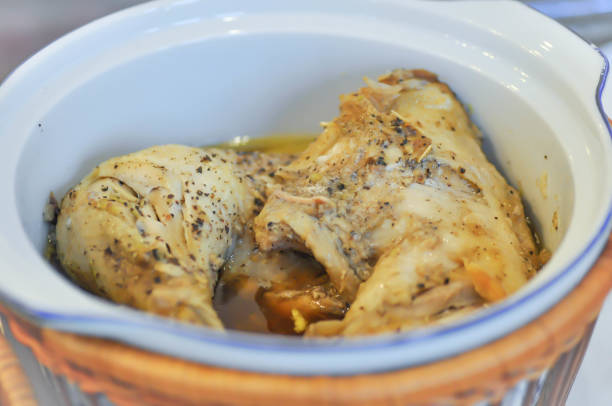 Tender chicken pieces seasoned with herbs in a small crockpot.