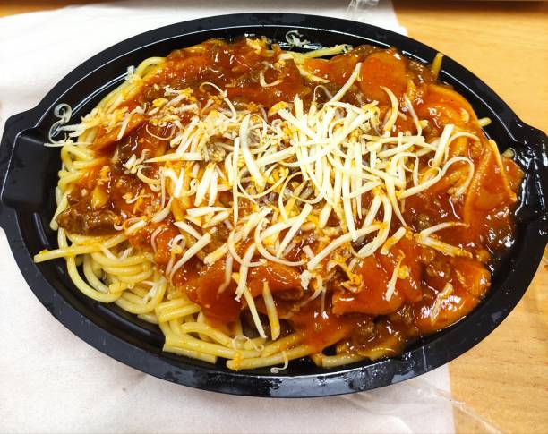 A serving of spaghetti topped with marinara sauce and shredded cheese in a black food container.