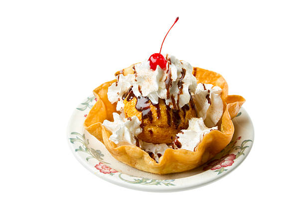 A delicious ice cream sundae in a waffle bowl topped with whipped cream, chocolate syrup, and a cherry.