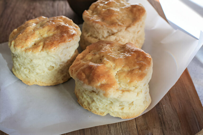 Freshly baked homemade biscuits arranged on parchment paper