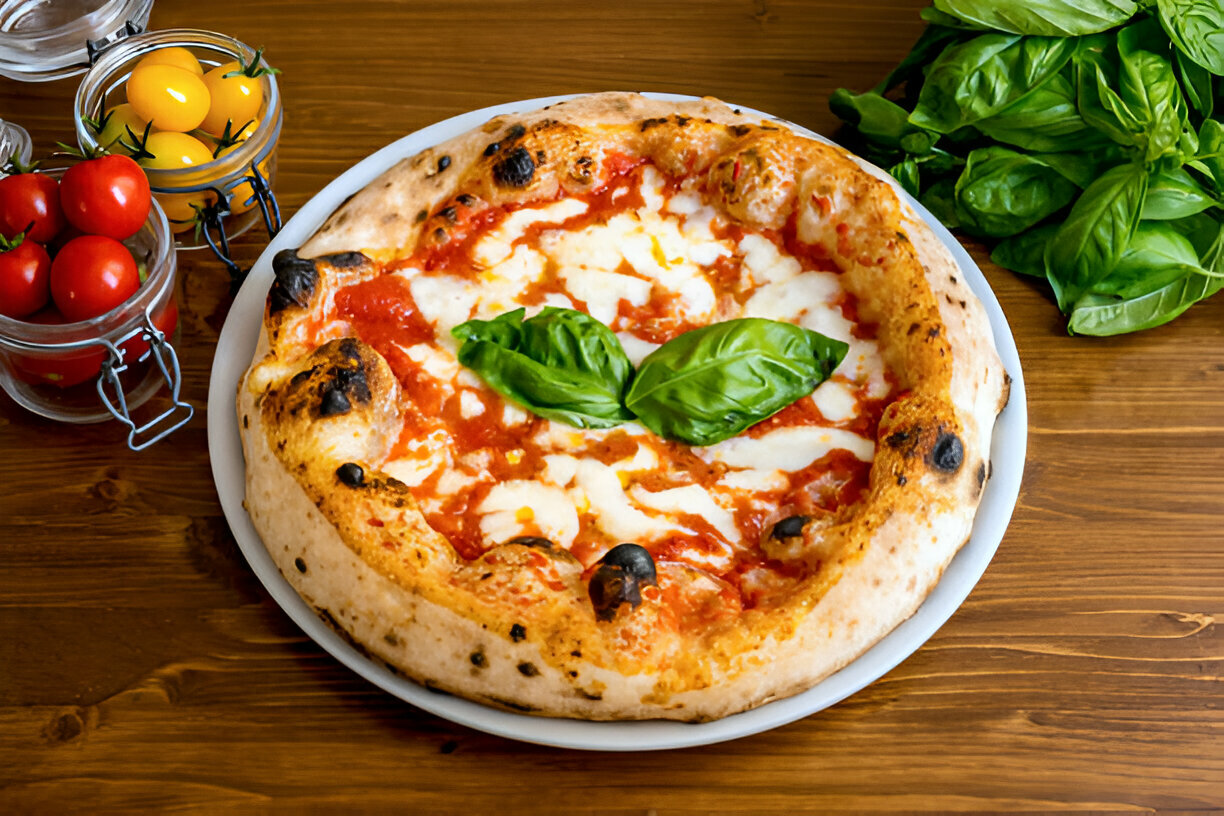 Delicious pizza topped with fresh mozzarella and basil on a wooden table.