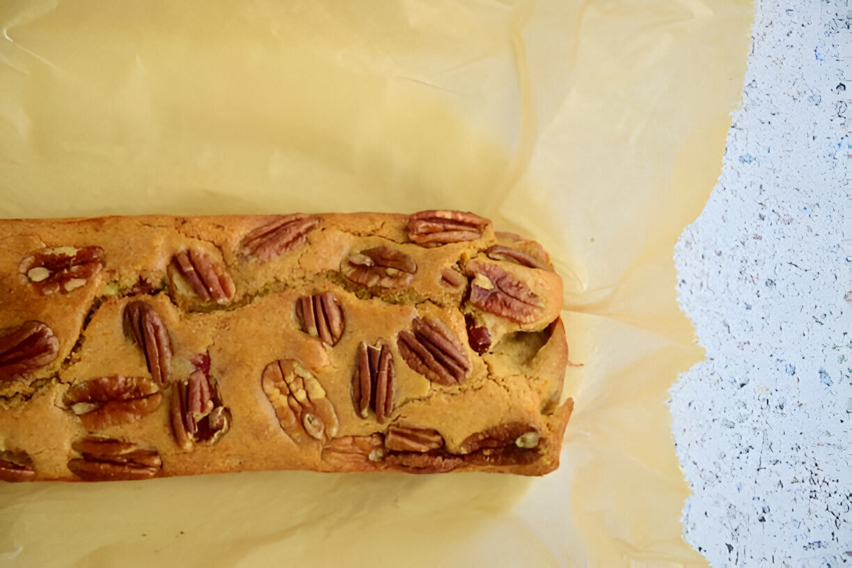 Loaf of pecan bread resting on parchment paper