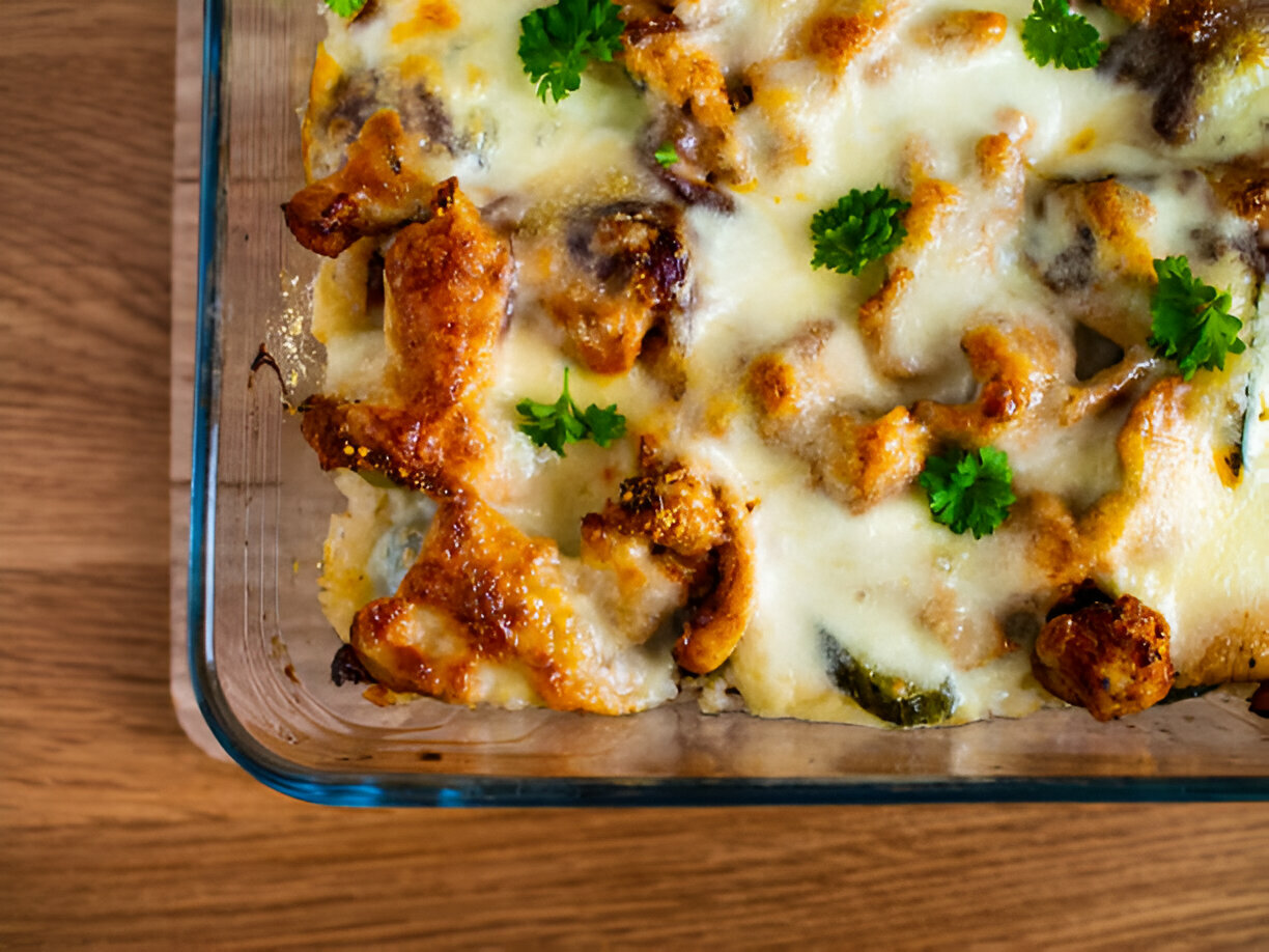 Baked dish with melted cheese and garnished with fresh parsley