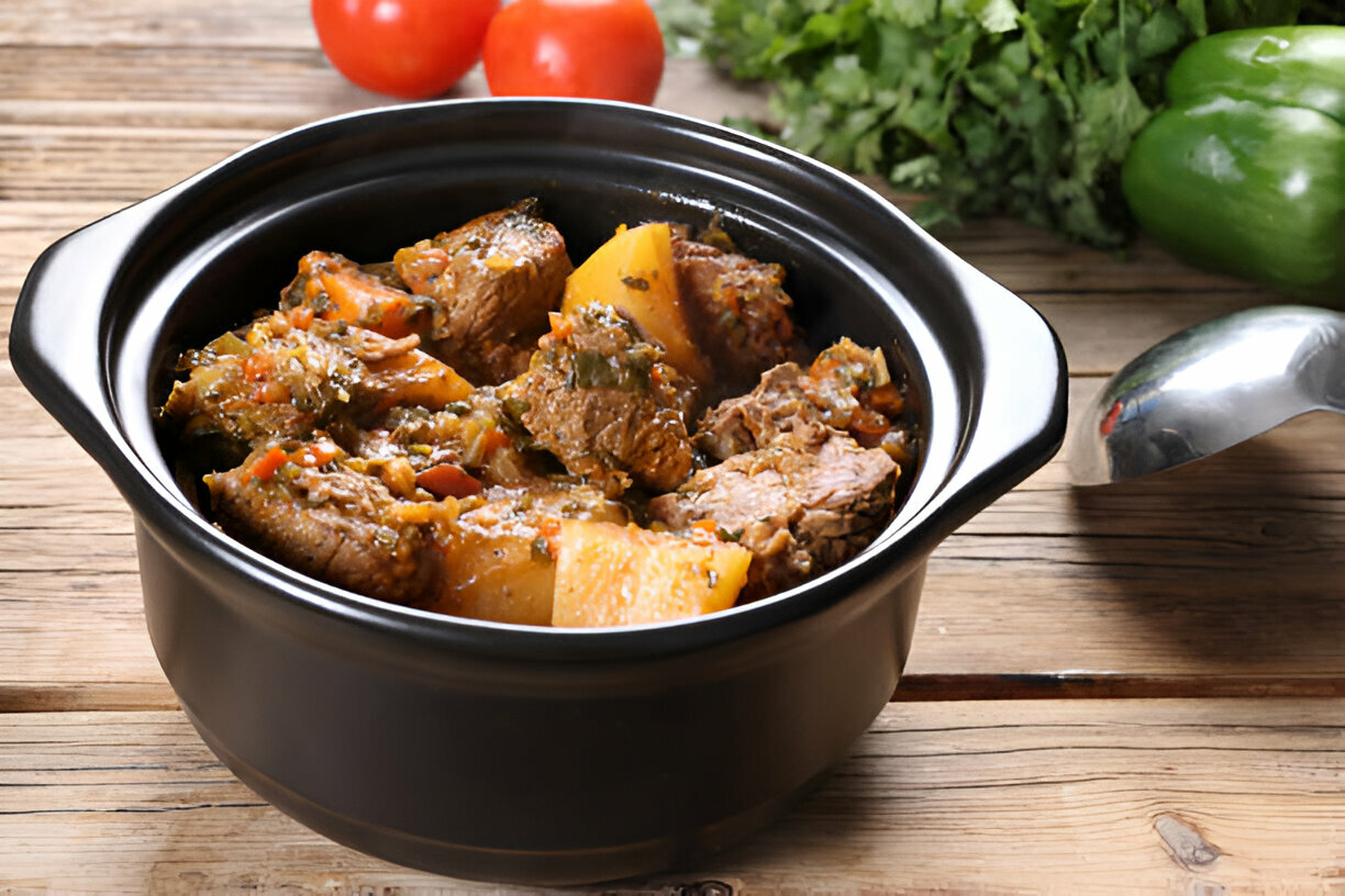 A hearty dish featuring sliced meat covered in gravy accompanied by baby potatoes, garnished with fresh parsley, served in a brown dish on a striped towel.